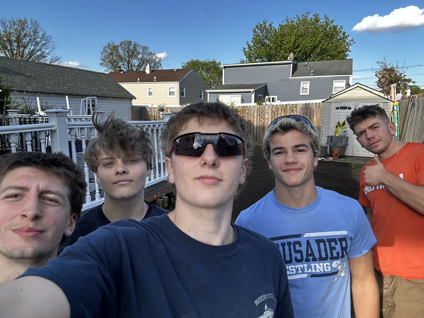 Crew members together in a backyard