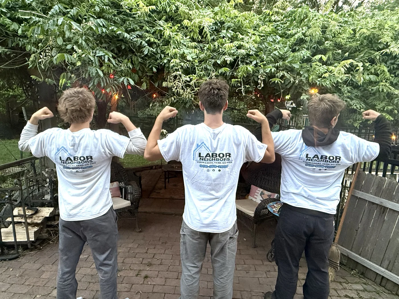 Three crew members showing their Labor Neighbors shirts