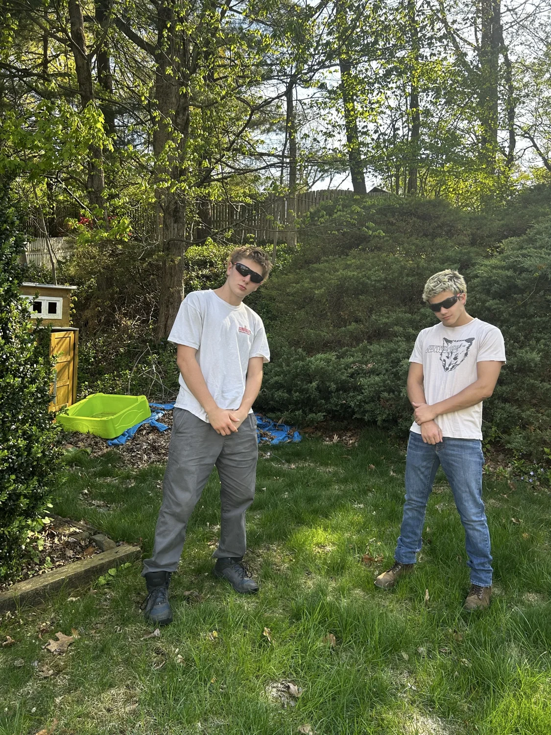 Two crew members standing in a garden